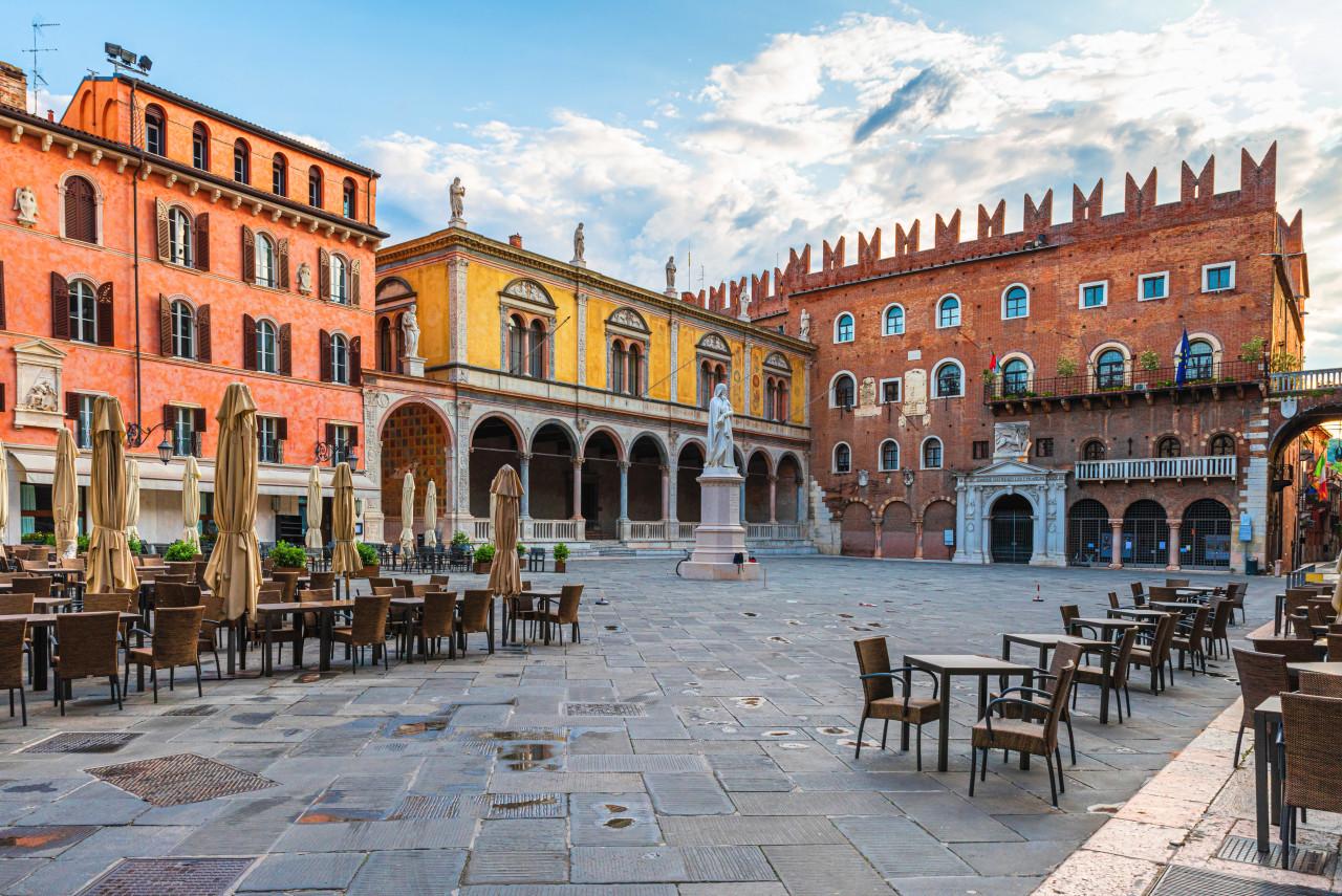 Verona old town square Piazza dei Signori with Dante statue street cafe with nobody Veneto Italy tourist destination